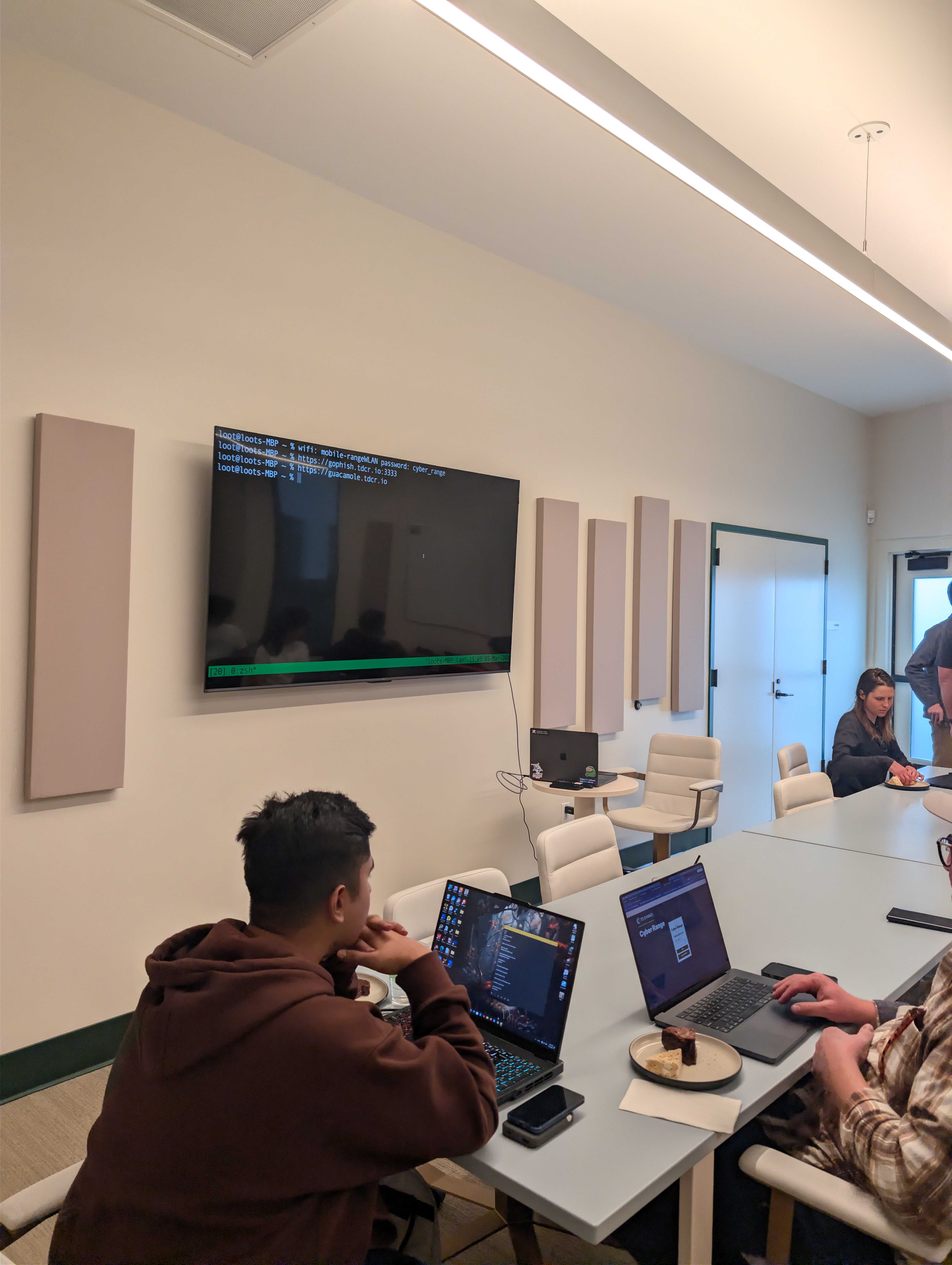 Participants hacking along with terminal output on screen