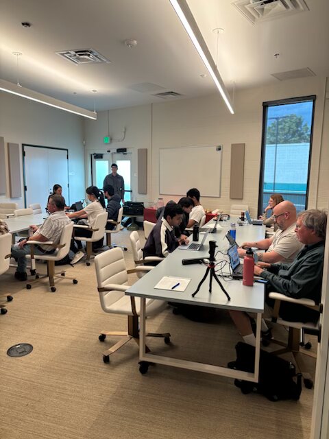 Participants collaborating at their laptops